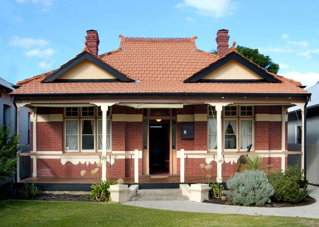 Front-on photo of red-brick and tiled cottage