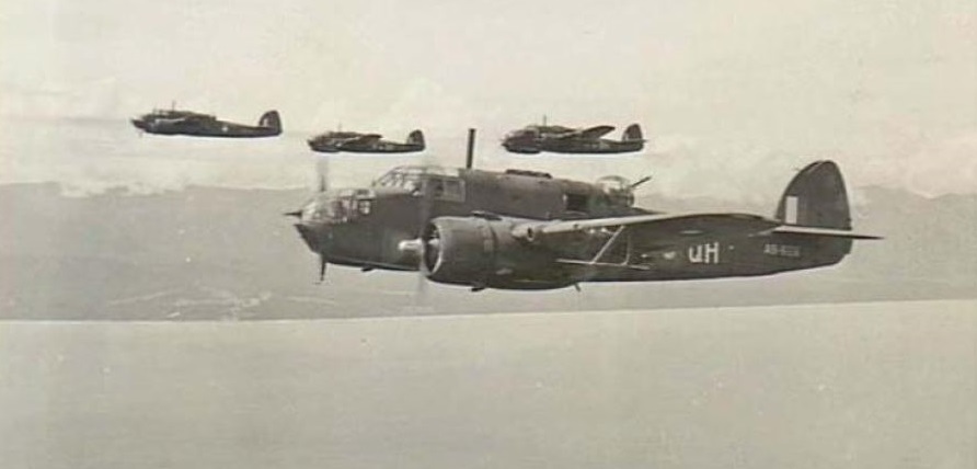 Four second world war bombers in flight off the coast