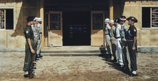 United Nations guards standing at ease outside the building the Korean War armistice was signed.