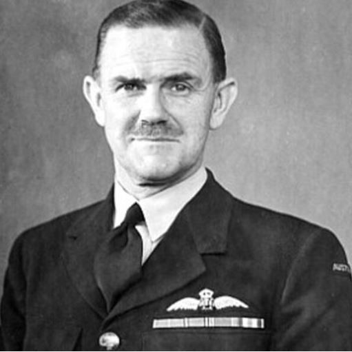 Formal portrait photo of smiling man in RAAF uniform