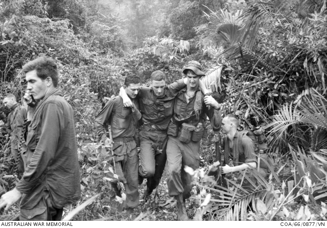 Australian Army soldiers from Charlie Company 5RAR carry their wounded mate to safety.