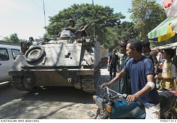 ADF soldiers patrol Dili streets aboard armoured personnel carriers (APCs)