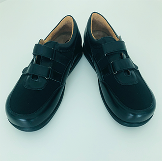 A pair of black shoes with velcro straps.