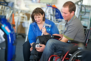 Female RAP provider assisting a male client in a wheelchair