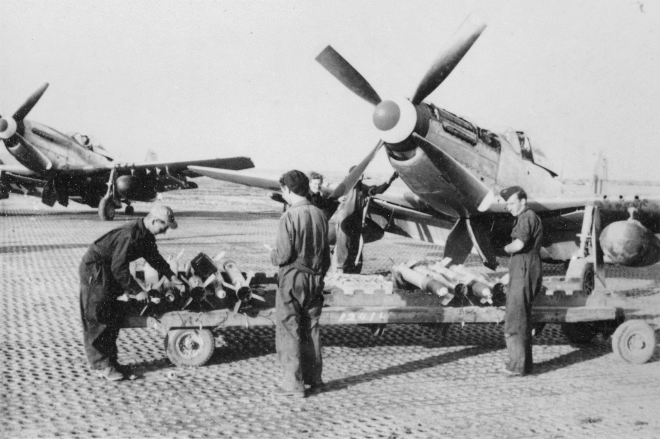 Ground crew arming a Mustang with rockets for a ground attack mission, Korea, 1950. (AWM P00337.009)