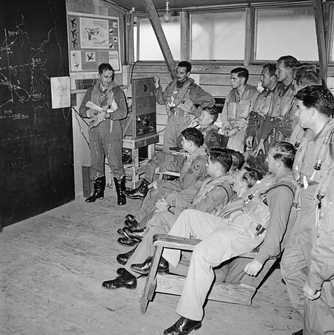 Pilots of No. 77 Squadron in an operations room briefing, Korea, 1954. (AWM JK1006)