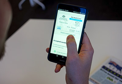 A client views the digital DVA White Card on their Huawei smartphone device