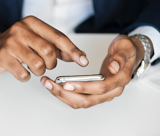The hands of a man using a mobile phone