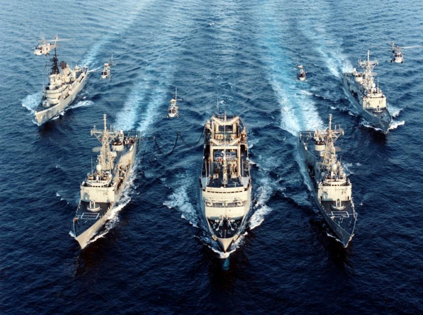 An image of Australian naval vessels and helicopters on their way to a rendezvous.