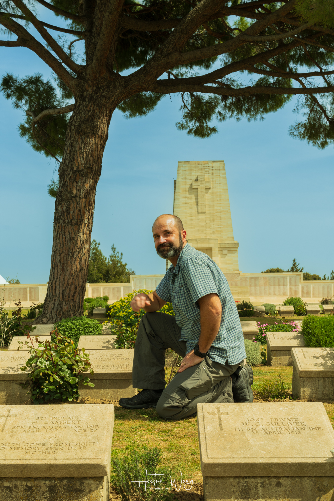 Shane kneeling at Lone Pine cemetery  