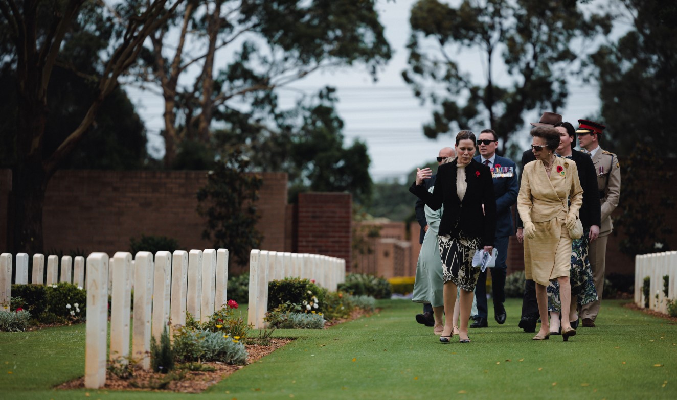 Secretary Alison Frame escorting Her Royal Highness Anne, the Princess Royal, through the Sydney War Cemetery in Rookwood.