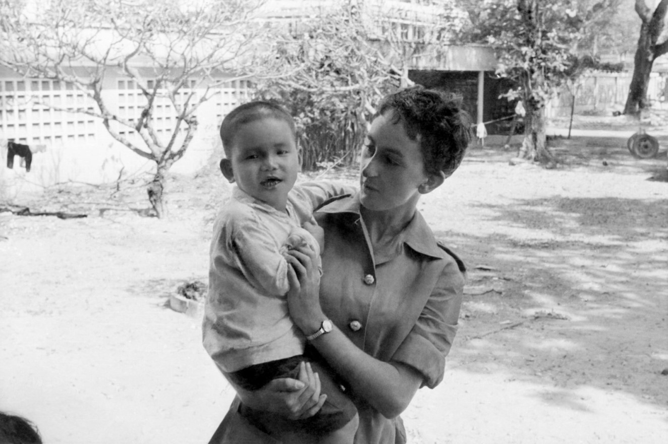 Jan McCarthy holding a little boy in Vietnam 