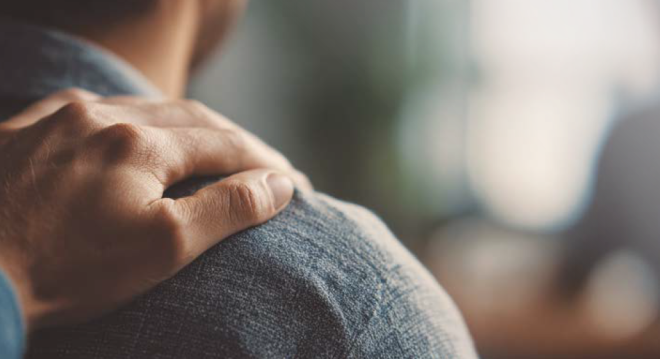 Supportive image of hand on shoulder 
