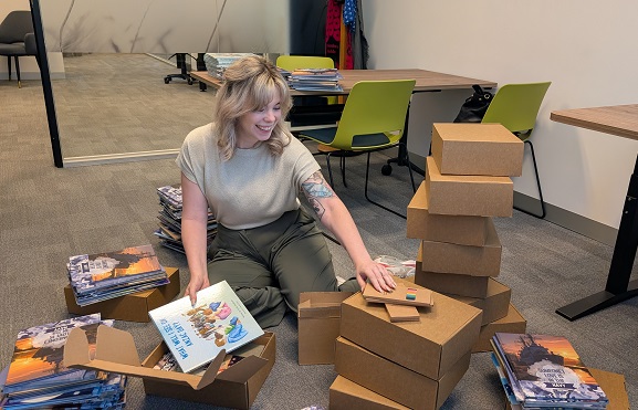 Annabelle Wilson packing children’s books and resources for the Veterans’ and Families’ Hubs.
