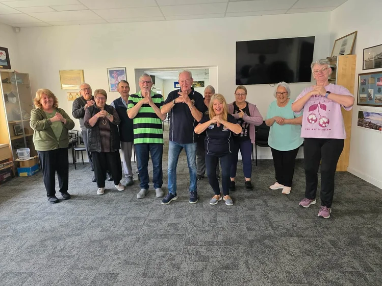 A group of elderly veteran community members exercising
