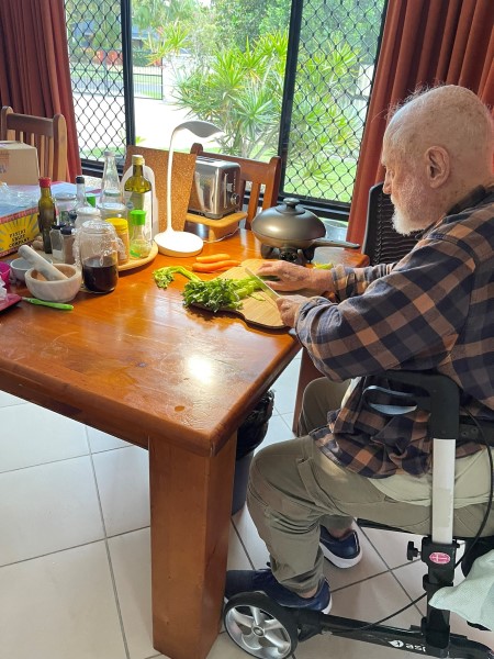Veteran chopping vegetables at his table
