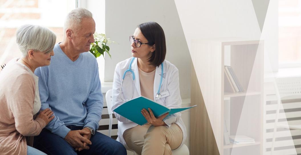 A female doctor speaking with a senior couple.