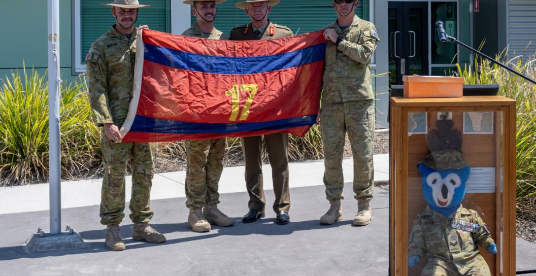Soldiers display 17th Construction Squadron flag from the Vietenam War