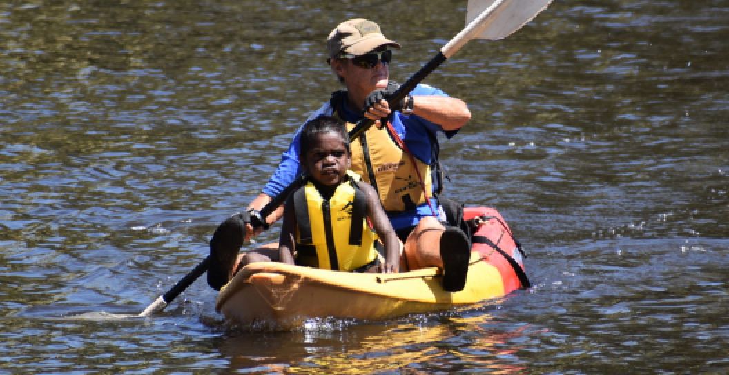 Veteran Pamela Dillon kayaks with a student