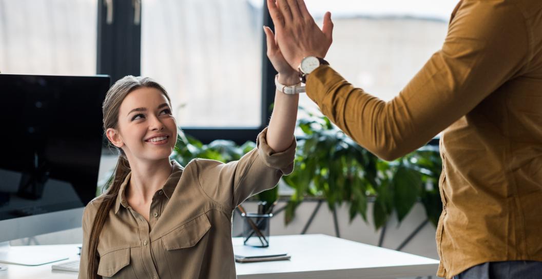 business-partners-giving-high-five-at-office