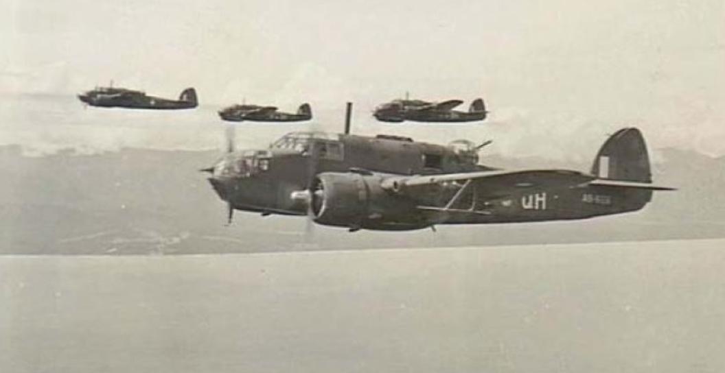 Four second world war bombers in flight off the coast