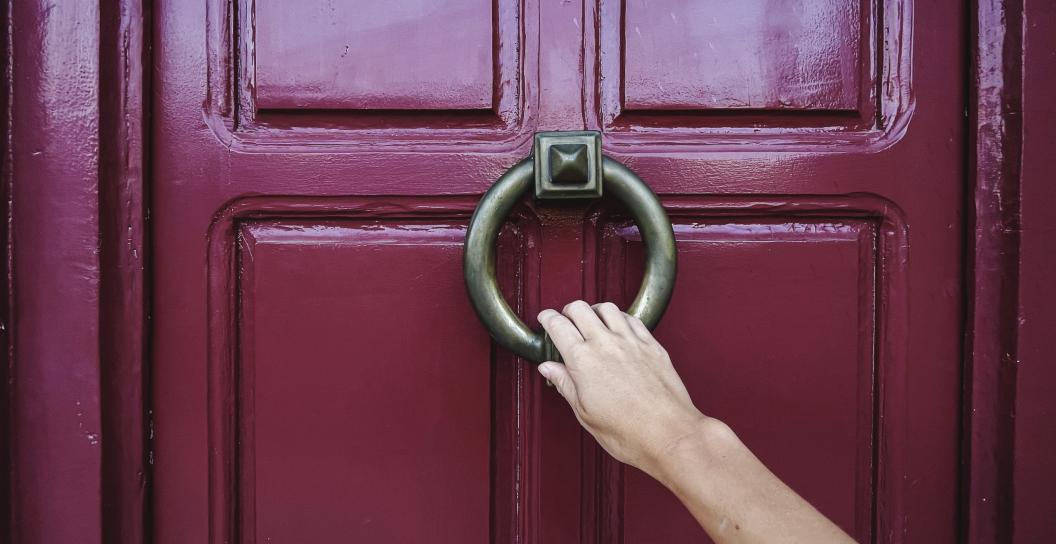 hand knocking on a door