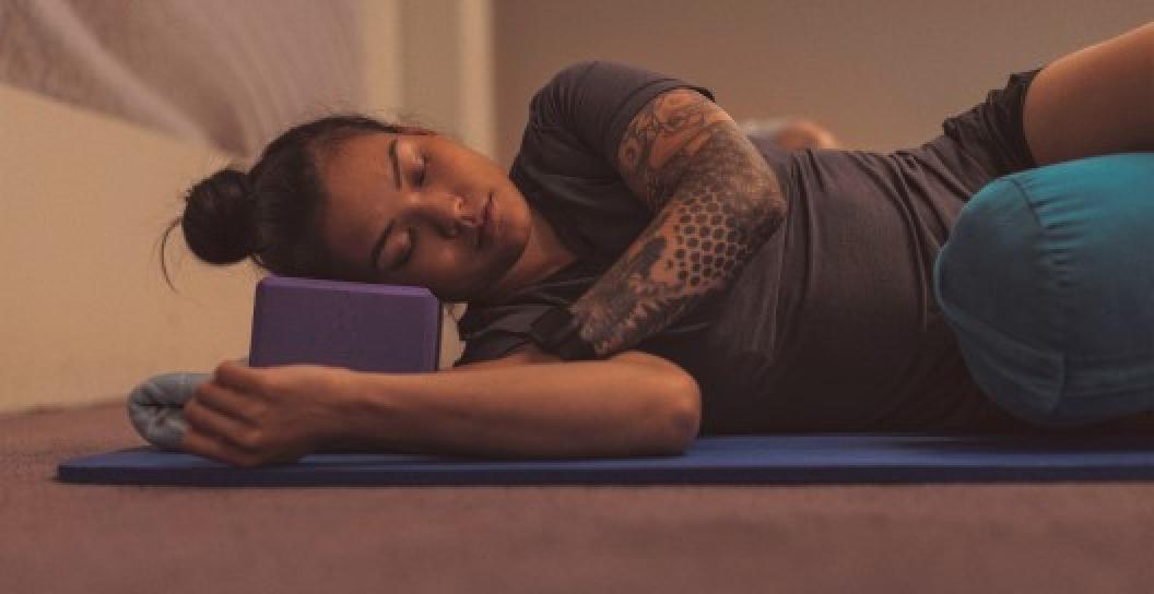 Person sleeping on yoga matt