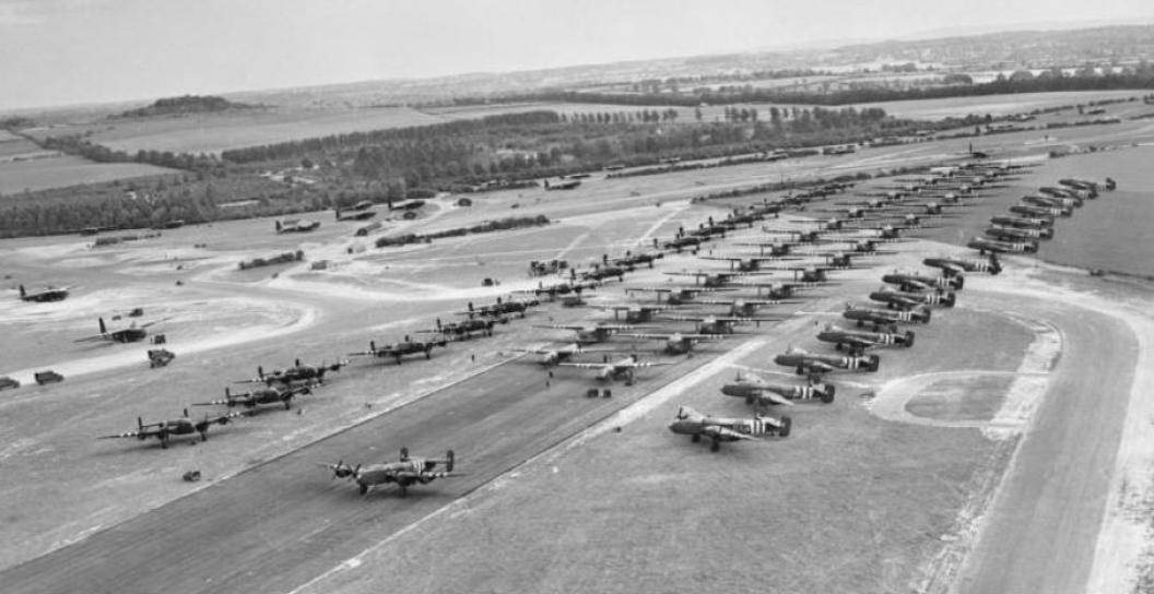 Dozens of Halifax bombers lined up on or next to a runway