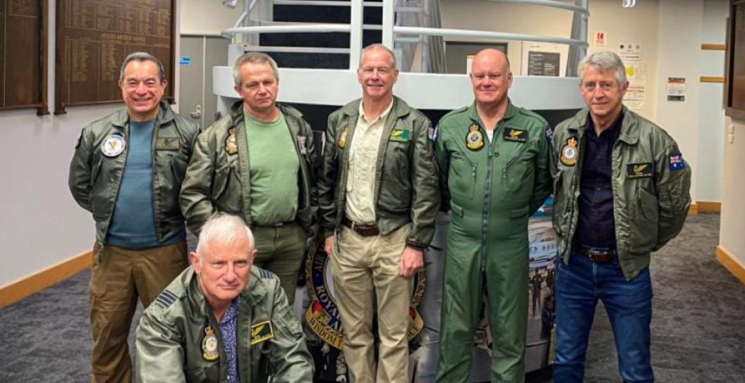 Six older men partially dressed in RAAF uniforms pose for the camera
