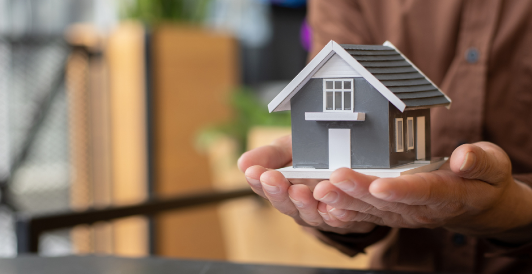 Tiny house held in palms of hands