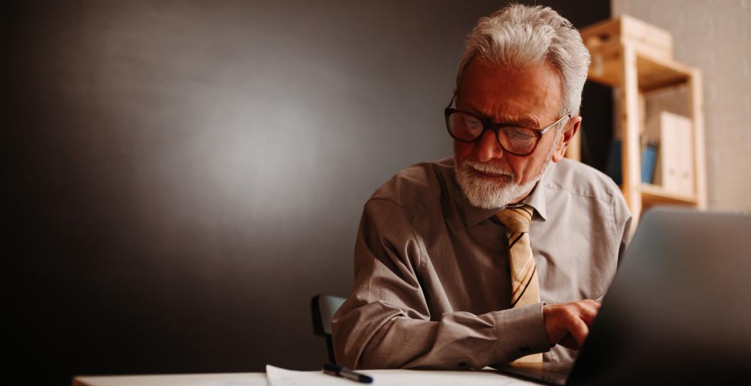 Older man working on laptop