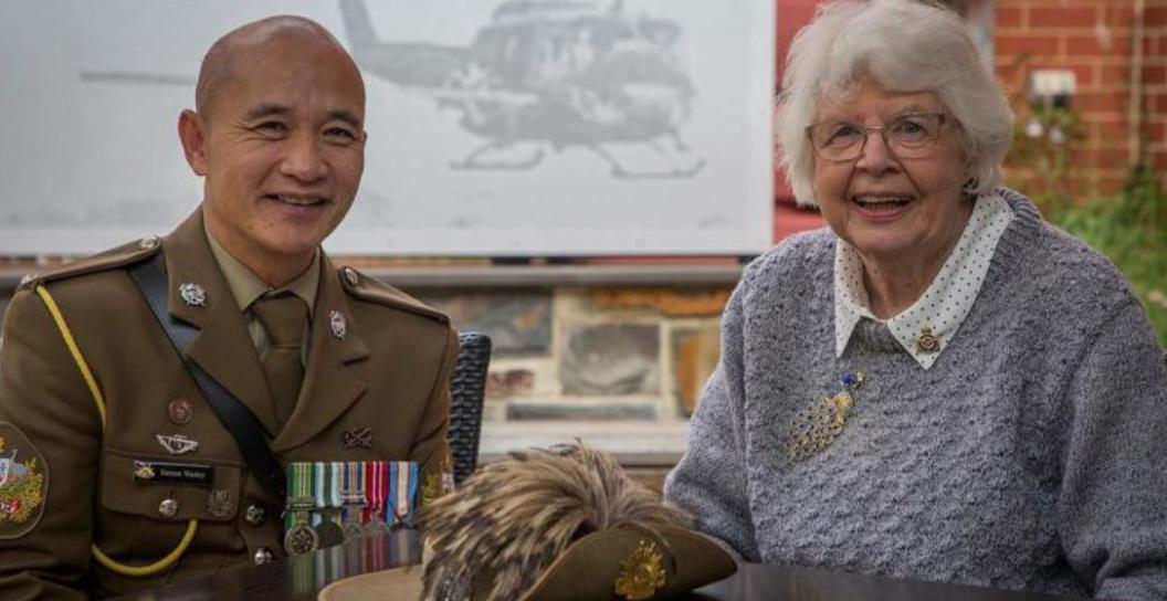 Warrant Officer in uniform poses with elderly woman