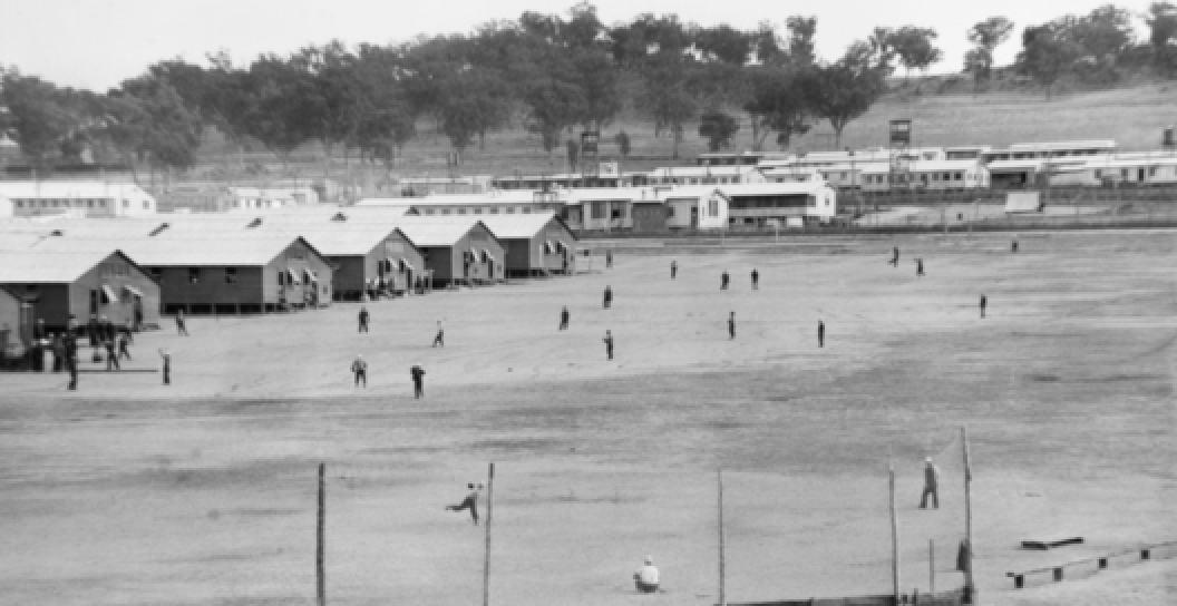 Japanese prisoners of war playing baseball. This photograph was taken for the far eastern liaison office as a basis for propaganda leaflets to be dropped over Japanese held islands during the Second World War.