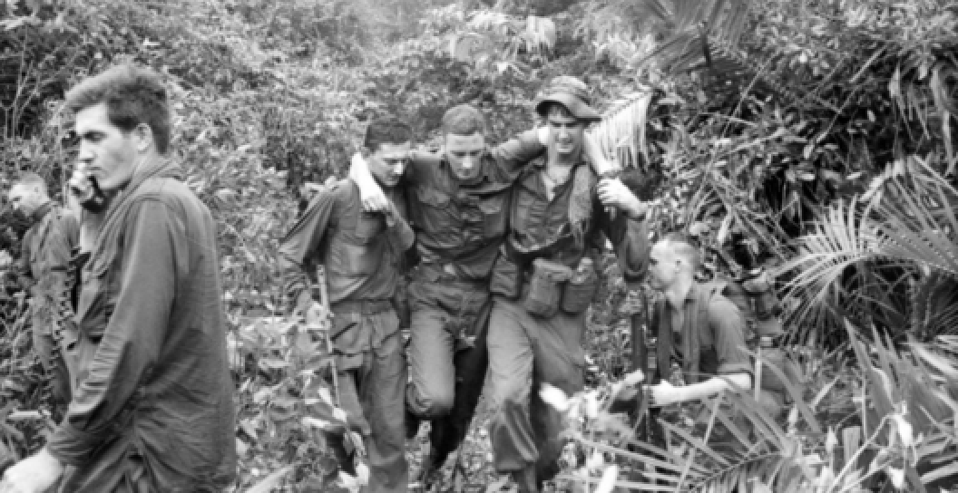 Australian Army soldiers from Charlie Company 5RAR carry their wounded mate to safety