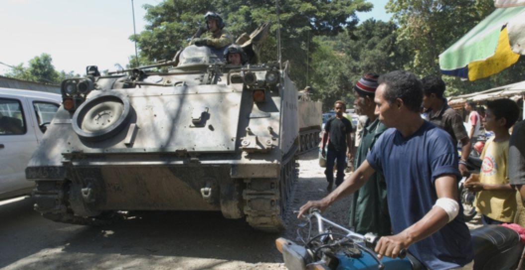 ADF soldiers patrol Dili streets aboard armoured personnel carriers (APCs)