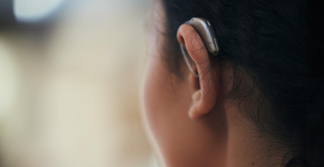 Woman wearing hearing aid looking away