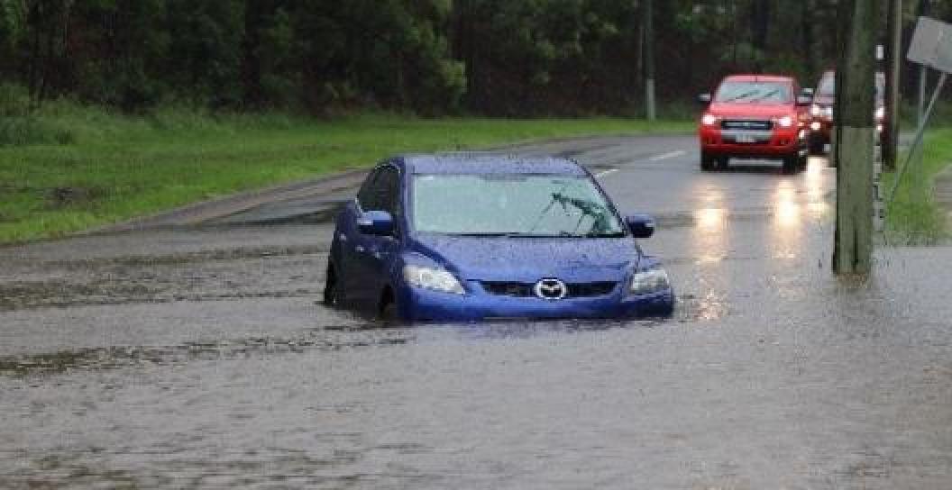 A car partially submerged in floodwaters