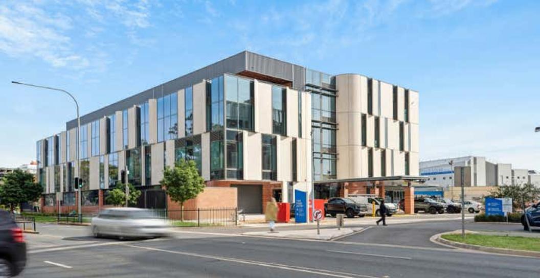 Exterior of the Playford Health & Wellbeing Precinct against a blue sky background