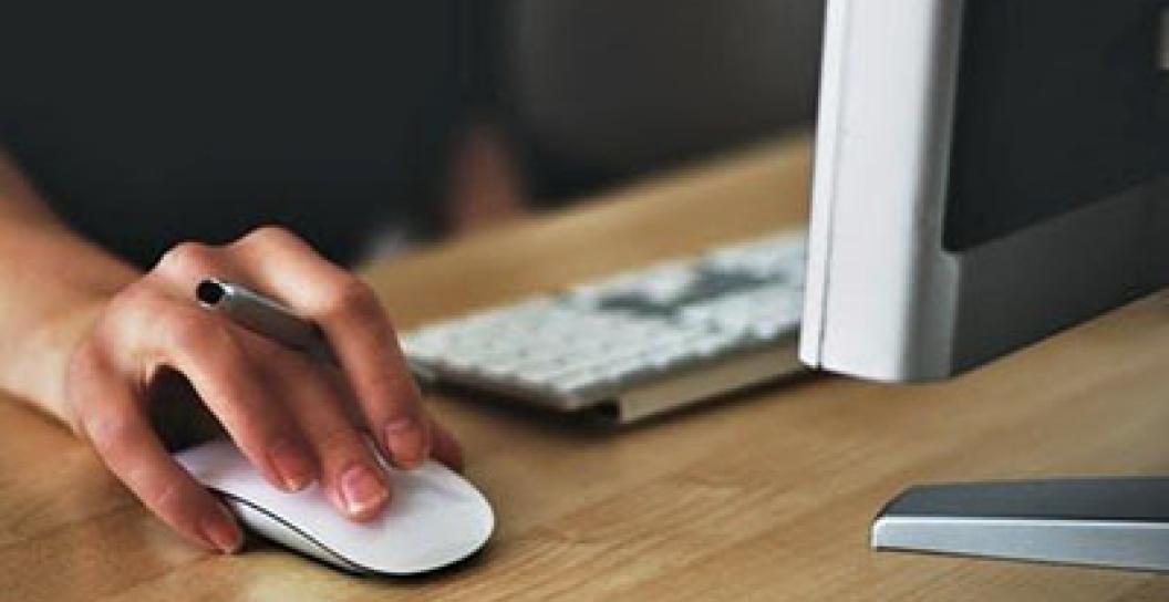 Hand holding a computer mouse