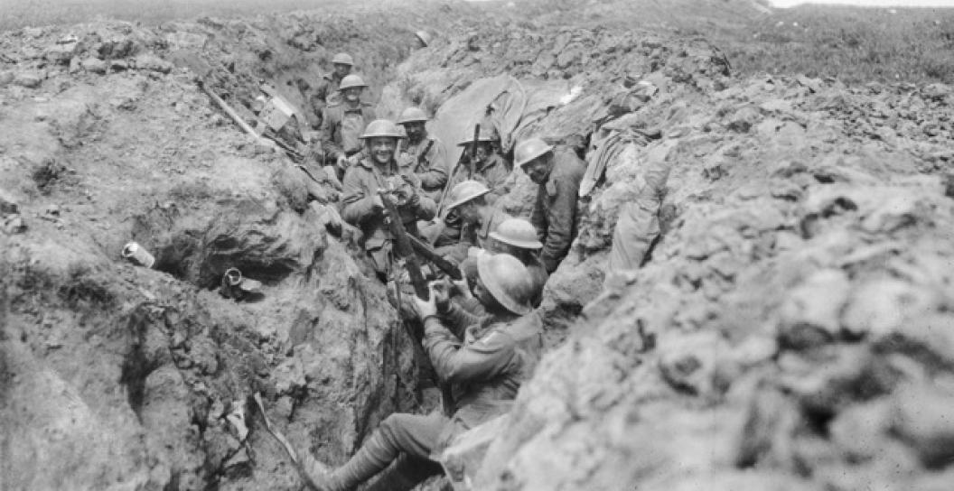 Six muddy soldiers in a trench