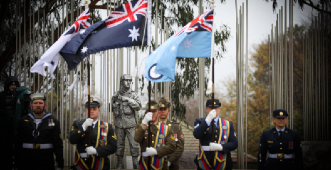 Australian Defence Force members holding flags at the National Commemorative Service marking the 75th anniversary of Australian service in Korea