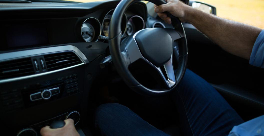 Man driving a car seen from the passenger seat