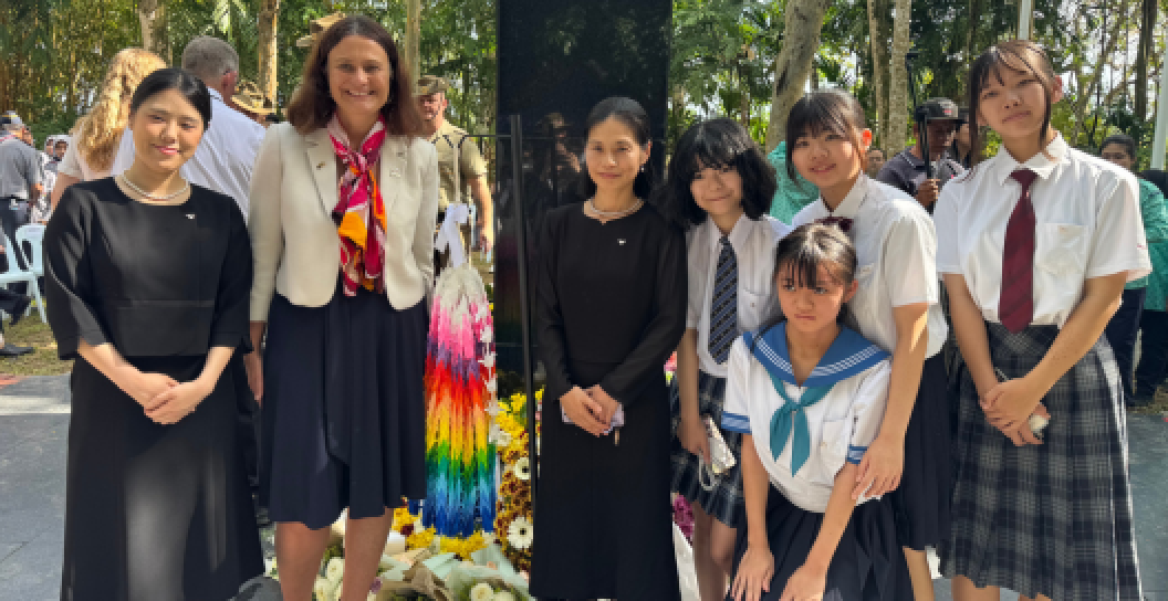 A photo of origami cranes, Japanese students and attendees on Sandakan Memorial Day