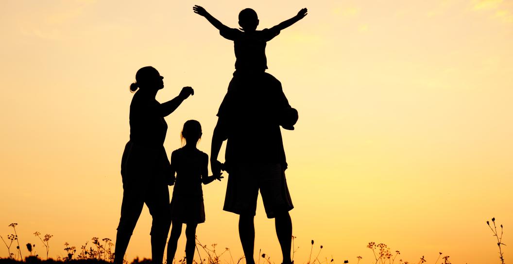 Silhouette of family at sunset.