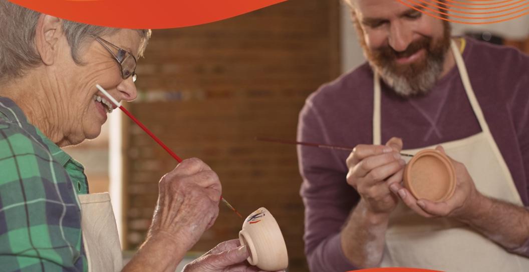 2 people painting a clay pot together and smiling text reads thrive 365