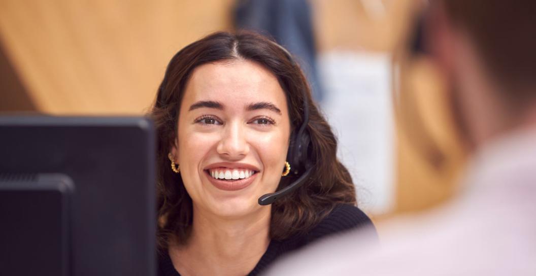 a woman wearing a headset in a call centre providing over the phone support