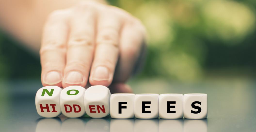 a hand turning over blocks that say no fees, with the word hidden fees underneath