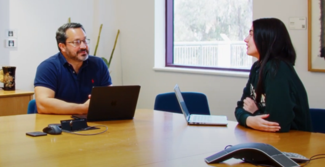 An image of two people at a desk studying