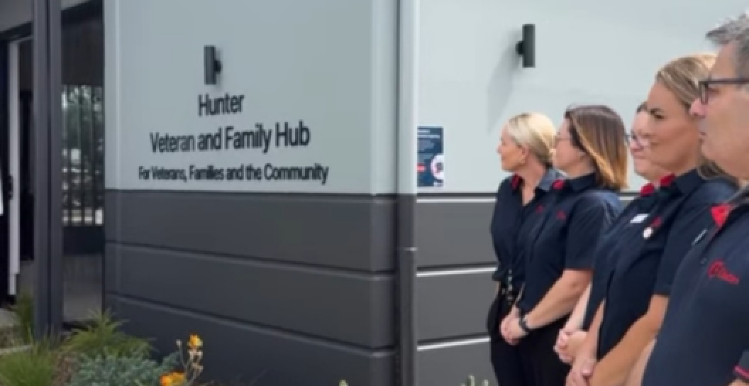 Men and women standing in front of the Veterans' and Families' Hub in Maitland