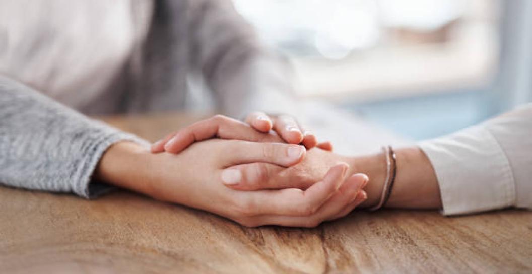 Person holding hands in a caring way